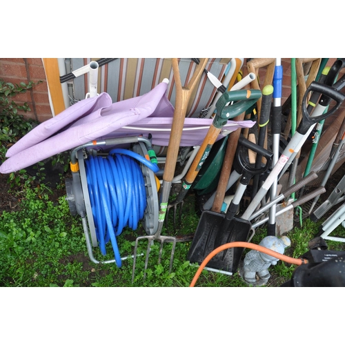 1008 - A LARGE QUANTITY OF GARDEN TOOLS AND FURNITURE including a boxed and unopened barbecue shelter, step... 