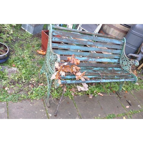 1017 - A WOODEN SLATTED GARDEN BENCH cast iron ends contain pierced foliate detailing 128cm wide (Condition... 