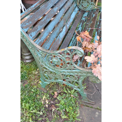 1017 - A WOODEN SLATTED GARDEN BENCH cast iron ends contain pierced foliate detailing 128cm wide (Condition... 