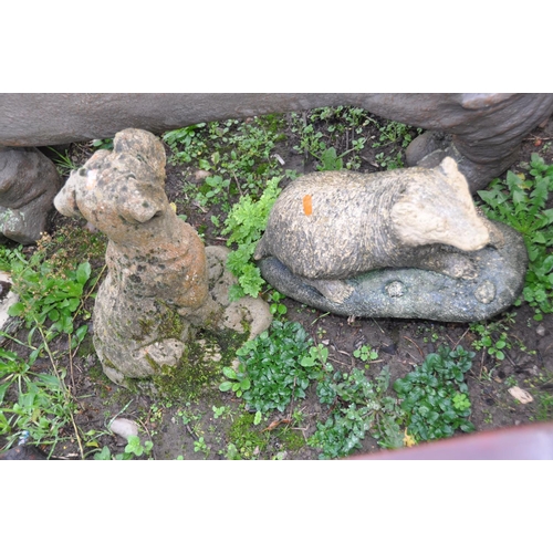 1018 - FOUR ANIMAL FIGURE GARDEN ORNAMENTS including a plastic Dachshund seat 115cm long, a composite Boxer... 