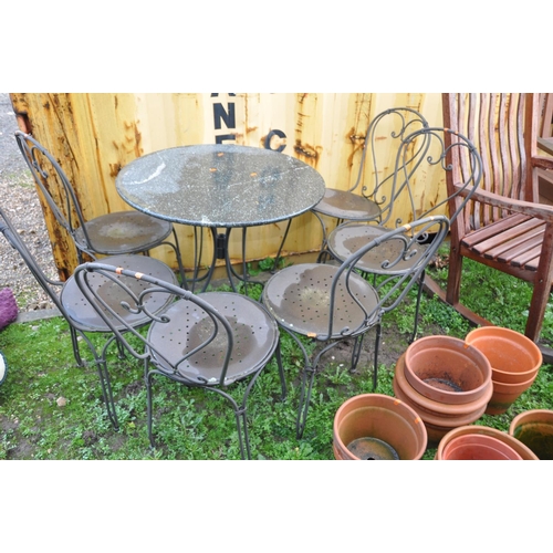 1026 - A HEAVY METAL FRAMED PATIO SET with a marble topped round table 75cm in diameter and six similar cha... 