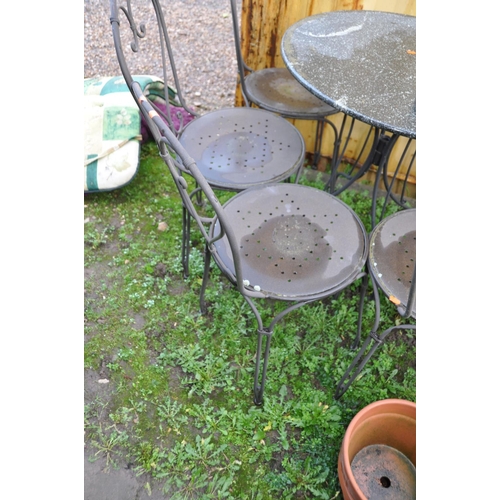 1026 - A HEAVY METAL FRAMED PATIO SET with a marble topped round table 75cm in diameter and six similar cha... 