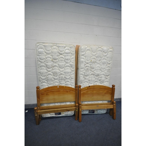 1216 - A PAIR OF REST ASSURED SINGLE MATTRESSES, with pine bed frames (condition - discolouration to bed fr... 