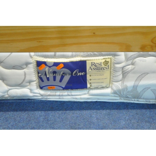 1216 - A PAIR OF REST ASSURED SINGLE MATTRESSES, with pine bed frames (condition - discolouration to bed fr... 