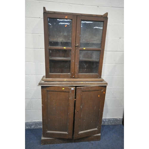 1220 - A VICTORIAN SCUMBLED PINE BOOKCASE, with double glazed doors above panelled cupboard doors, width 10... 