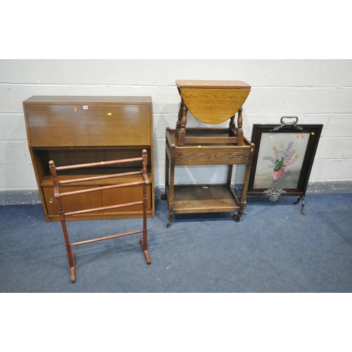 1224 - A TEAK BUREAU (missing glass doors) along with an oak trolley, a brass foliate needlework fire scree... 