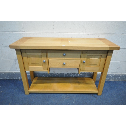 1230 - A SOLID LIGHT OAK SIDEBOARD, with two doors flanking two drawers, length 123cm x depth 44cm x height... 