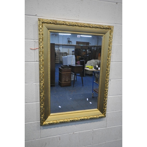 1243 - A LARGE RECTANGULAR GILT FRAME WALL MIRROR, with foliate detail, 104cm x 84cm (good condition)