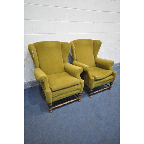 1256 - A PAIR OF EARLY 20TH CENTURY OAK WING BACK ARMCHAIRS, on a turned base united by a stretcher, width ... 