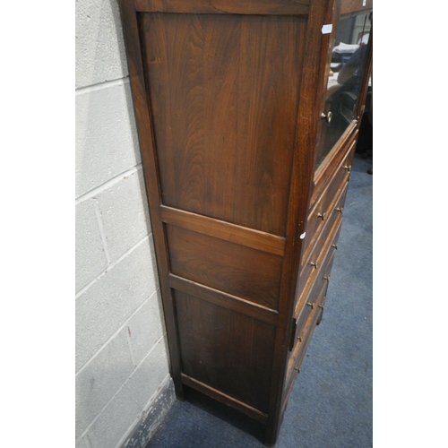 1322 - A 20TH CENTURY OAK CABINET, with a single glazed door, above five drawers, width 77cm x depth 46cm x... 