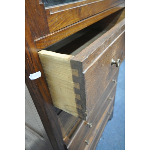 1322 - A 20TH CENTURY OAK CABINET, with a single glazed door, above five drawers, width 77cm x depth 46cm x... 