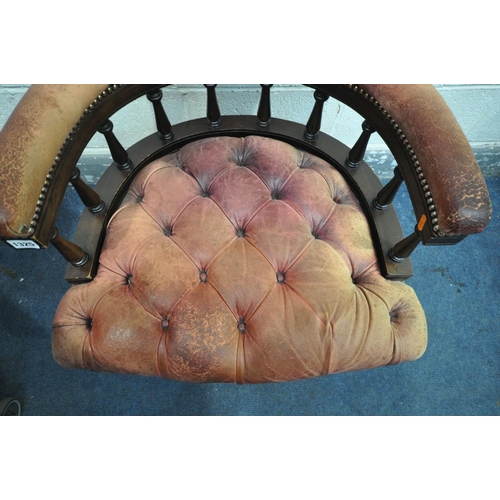 1325 - A BUTTONED BURGUNDY LEATHER ARMCHAIR, with a scrolled back, on cylindrical tapered legs, width 69cm ... 