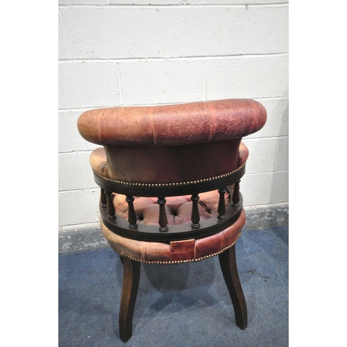 1325 - A BUTTONED BURGUNDY LEATHER ARMCHAIR, with a scrolled back, on cylindrical tapered legs, width 69cm ... 