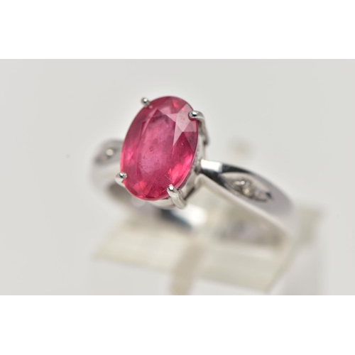 17 - AN 18CT WHITE GOLD RING, centrally set with an oval cut orange/red colour corundum, flanked with two... 