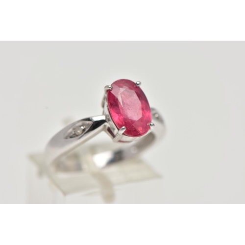 17 - AN 18CT WHITE GOLD RING, centrally set with an oval cut orange/red colour corundum, flanked with two... 