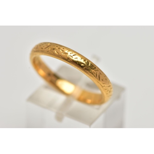 18 - A YELLOW METAL BAND RING, with scroll engraved detail, width of band approximately 4mm, stamped 22ct... 