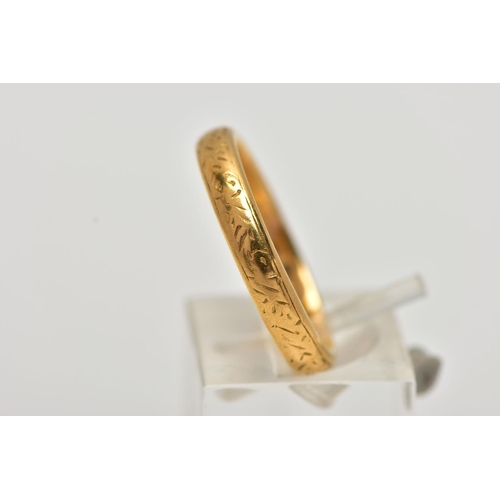 18 - A YELLOW METAL BAND RING, with scroll engraved detail, width of band approximately 4mm, stamped 22ct... 