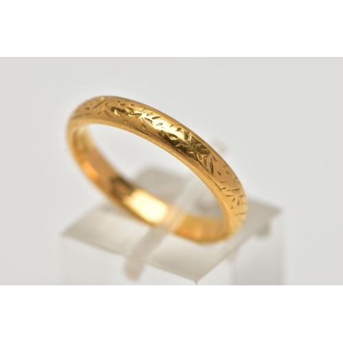 18 - A YELLOW METAL BAND RING, with scroll engraved detail, width of band approximately 4mm, stamped 22ct... 