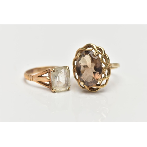 22 - A 9CT GOLD SMOKY QUARTZ RING AND A QUARTZ RING, the first a large oval cut smoky quartz, set within ... 