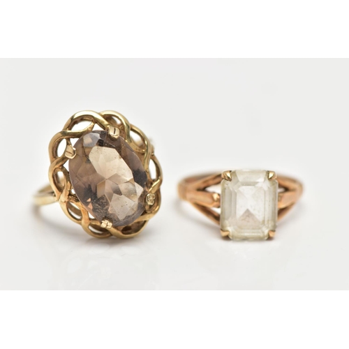 22 - A 9CT GOLD SMOKY QUARTZ RING AND A QUARTZ RING, the first a large oval cut smoky quartz, set within ... 