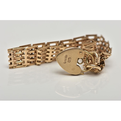 39 - A 9CT GOLD GATE BRACELET, designed with a series of five bar links, some textured some plain polishe... 