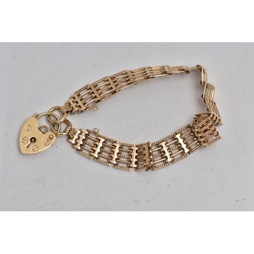 39 - A 9CT GOLD GATE BRACELET, designed with a series of five bar links, some textured some plain polishe... 