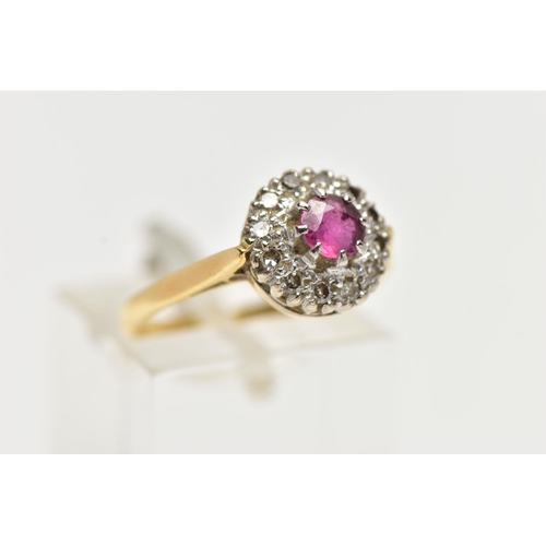 4 - AN 18CT GOLD RUBY AND DIAMOND CLUSTER RING, centering on a circular cut ruby, in an eight claw setti... 