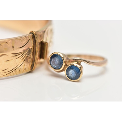 43 - A 9CT GOLD SAPPHIRE RING AND A GOLD PLATED HINGED BANGLE, the ring of a cross over design, set with ... 