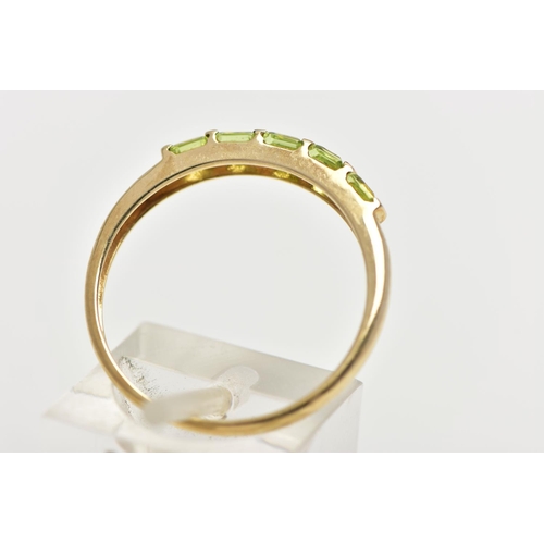 47 - A 9CT GOLD PERIDOT RING, designed with a row of five bar set, square cut peridots, to a polished ban... 