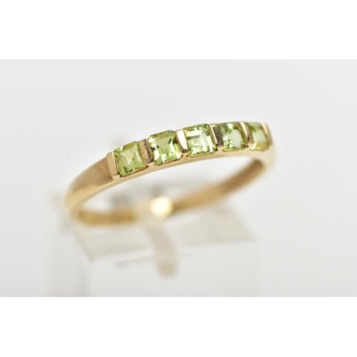 47 - A 9CT GOLD PERIDOT RING, designed with a row of five bar set, square cut peridots, to a polished ban... 