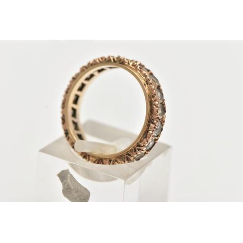 5 - A YELLOW METAL FULL ETERNITY RING, set with a row of circular cut colourless stones assessed as spin... 