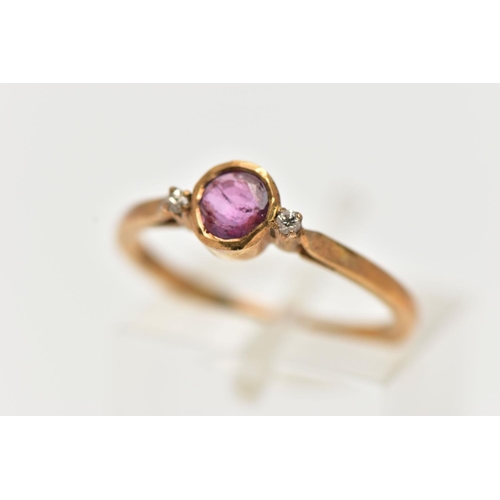 50 - A YELLOW METAL RUBY AND DIAMOND RING, designed with a collet set ruby, flanked with two small round ... 