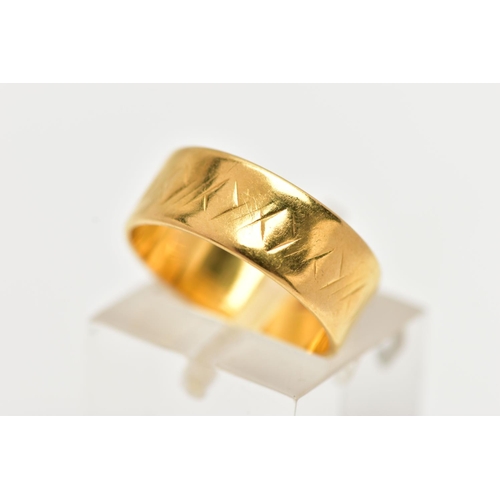 6 - A 22CT YELLOW GOLD WIDE BAND RING, worn textured design all round, approximate band width 6.5mm, hal... 