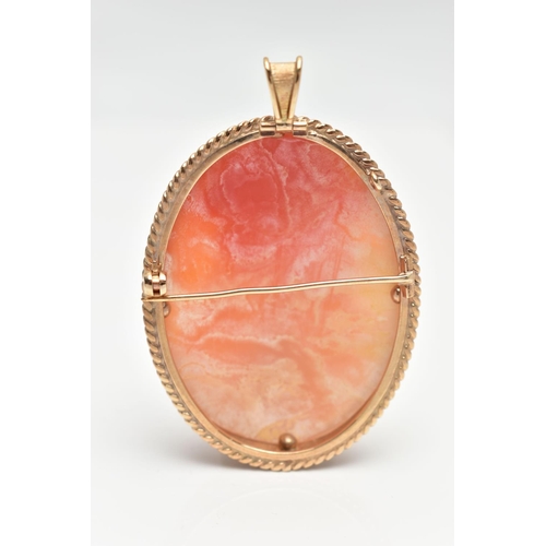 64 - A 9CT GOLD CAMEO BROOCH, of an oval form, carved shell depicting a lady in profile, collet set to a ... 