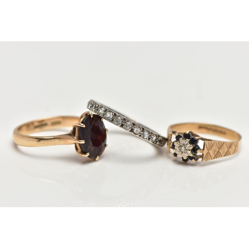 67 - THREE GEM SET RINGS, the first designed with an oval cut garnet in an eight claw setting with openwo... 