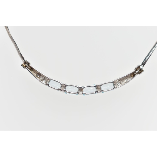 74 - A 9CT WHITE GOLD TOPAZ PENDANT NECKLACE, designed with a curved bar pendant bar set with a row of fo... 