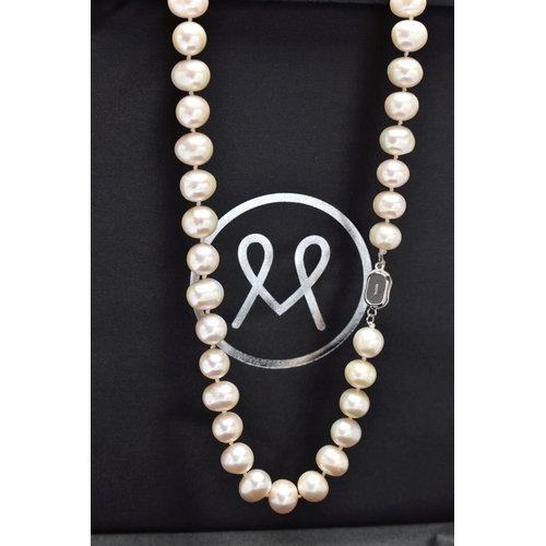 76 - A CULTURED PEARL NECKLACE, a single strand of baroque cultured white pearls with a pink hue, forty t... 