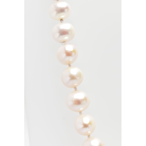 76 - A CULTURED PEARL NECKLACE, a single strand of baroque cultured white pearls with a pink hue, forty t... 