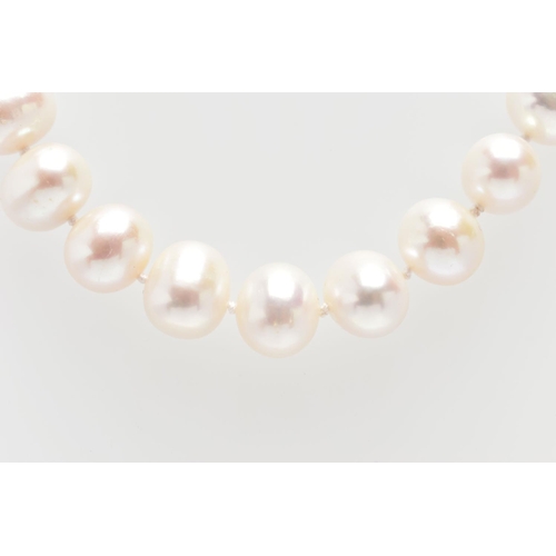 76 - A CULTURED PEARL NECKLACE, a single strand of baroque cultured white pearls with a pink hue, forty t... 