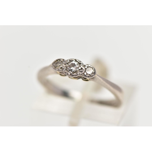 79 - A WHITE METAL THREE STONE DIAMOND RING, to the centre sits a round brilliant cut diamond in an illus... 