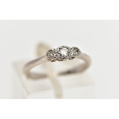 79 - A WHITE METAL THREE STONE DIAMOND RING, to the centre sits a round brilliant cut diamond in an illus... 