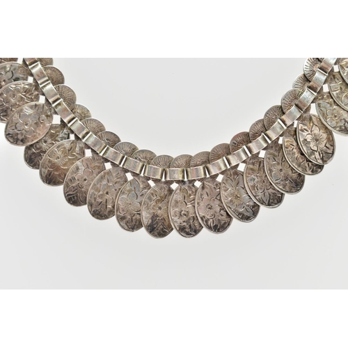 82 - A VICTORIAN WHITE METAL FRINGE CHAIN, designed as a series of floral detailed oval links, fitted wit... 