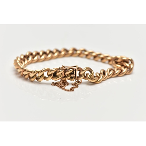 9 - A YELLOW METAL CURB LINK BRACELET, polished yellow metal, fitted with an integrated box clasp with a... 