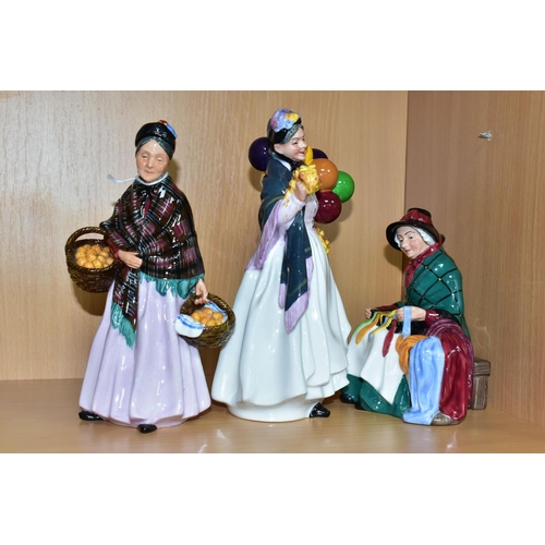 393 - THREE ROYAL DOULTON FIGURINES DEPICTING STREET SELLERS, comprising Silks and Ribbons HN2017, The Ora... 