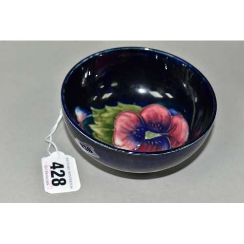 428 - A SMALL MOORCROFT POTTERY FOOTED BOWL, in Blue Pansy pattern, with a tube lined red and purple pansy... 