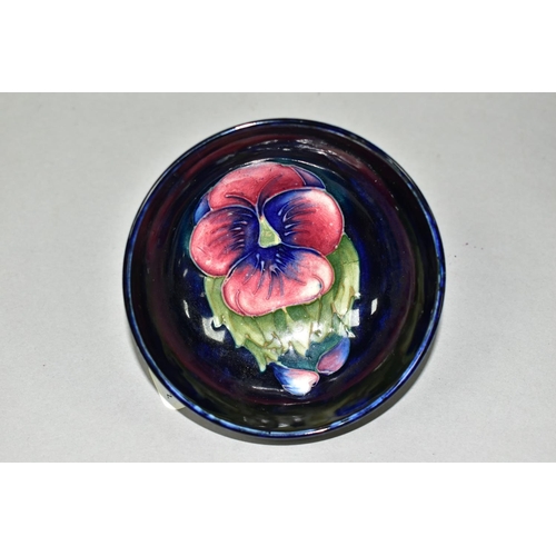 428 - A SMALL MOORCROFT POTTERY FOOTED BOWL, in Blue Pansy pattern, with a tube lined red and purple pansy... 