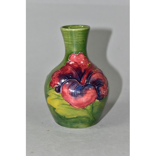 434 - A MOORCROFT POTTERY HIBISCUS PATTERN BUD VASE, of baluster form, with tube lined yellow, pink and pu... 