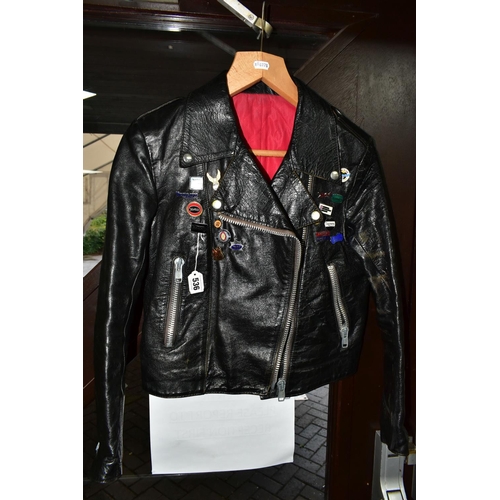 536 - A BLACK LEATHER PIN BADGE BIKER'S JACKET, size small, Frank N Furter style, with sixteen metal pin b... 