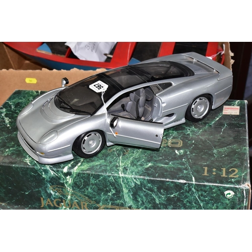 567 - A MAISTO DIE CAST MODEL OF A JAGUAR XJ220,  1/12th scale complete with box and display stand, approx... 