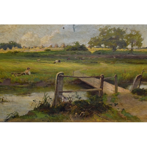 527 - ERNEST WALBOURNE (1872-1927) AN ENGLISH SCHOOL LANDSCAPE, a male figure is in repose in a field beyo... 